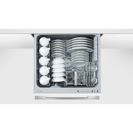 Dishwasher with dishes inside on a white background