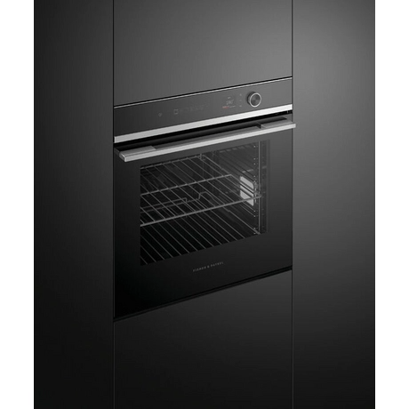 Black built-in oven with glass door on a dark gray background