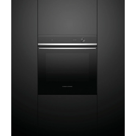 Black oven with silver handle on a black background