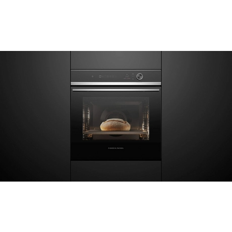 Modern kitchen oven with bread inside on a black background