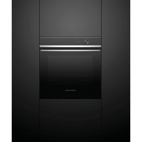Black oven with silver handle on a black background