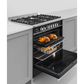 Stainless steel range cooker oven with open door showing roasted chicken and vegetables inside.