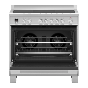 Stainless steel oven with open door on a white background