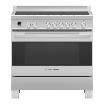 Stainless steel induction range cooker with manual controls on a white background