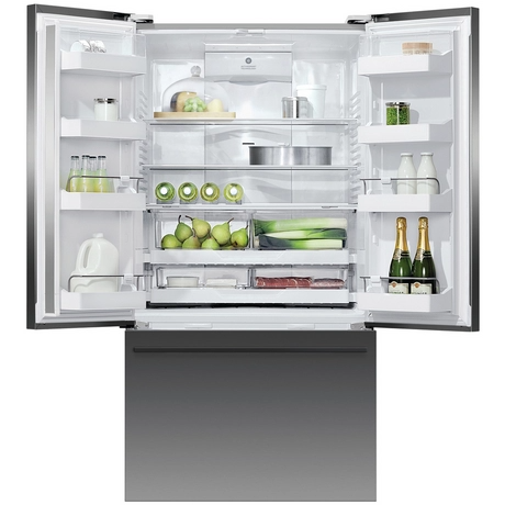 Open refrigerator with various food items inside on a white background