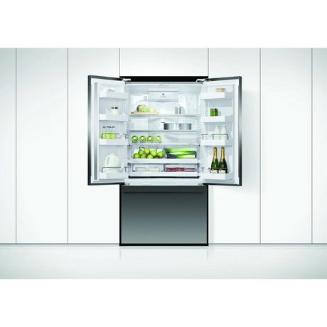 Modern refrigerator with open door displaying various items on a white kitchen background