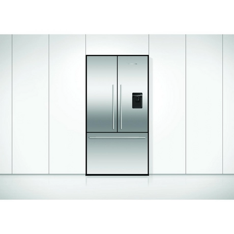Stainless steel refrigerator in a kitchen with white cabinets