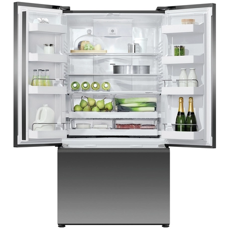 Open refrigerator with various food items inside on a white background