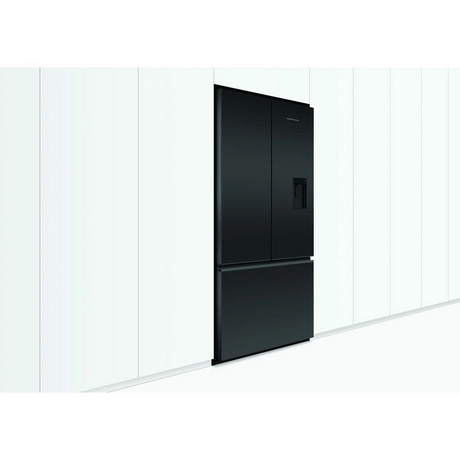 Black refrigerator against a white wall.