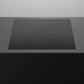 Black induction cooktop on a grey countertop