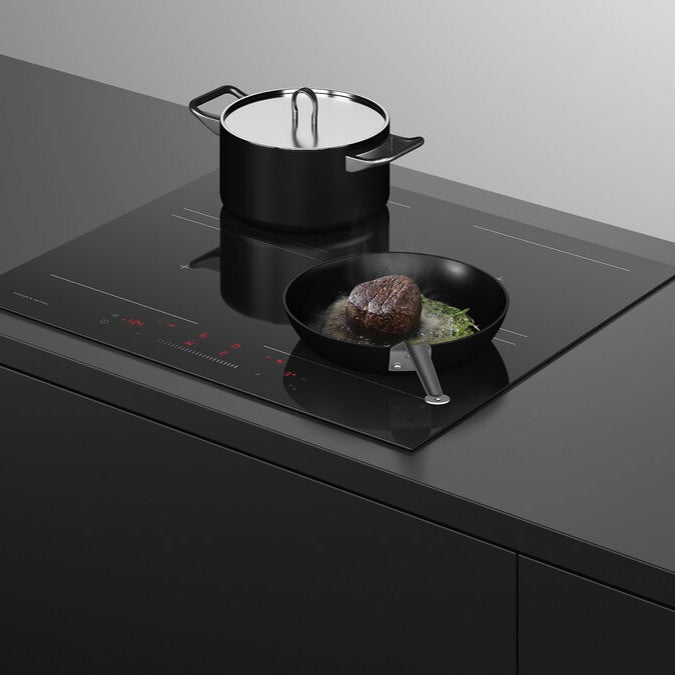 Black induction cooktop with a pot and pan